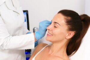 Close-up. Before the procedure for facial contouring or plastic surgery, the cosmetologist makes markings on the patient’s face. Time to prepare for a cosmetic procedure.